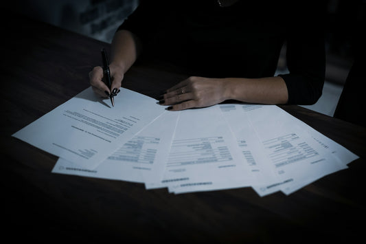 Homeowner sorting through paperwork at a kitchen table