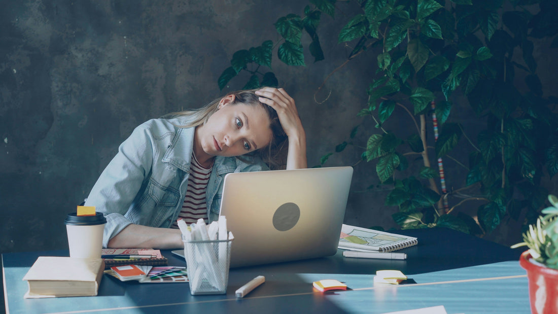 Stressed small business owner reviewing employee turnover costs at desk with documents