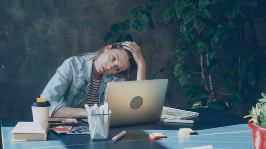 Stressed small business owner reviewing employee turnover costs at desk with documents