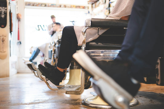 Interior of a California barber shop with clean floors, organized chairs, and safety mats to prevent slips and falls.